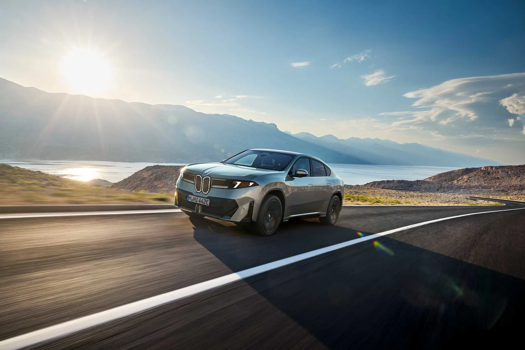 灰色BMW iX4 50 xDrive純電SUV Coupe行駛於海岸公路